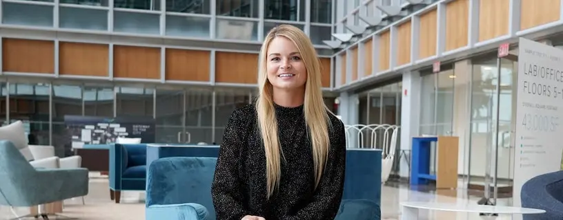 Colleen O’Connor seated at a Boston office and laboratory construction site
